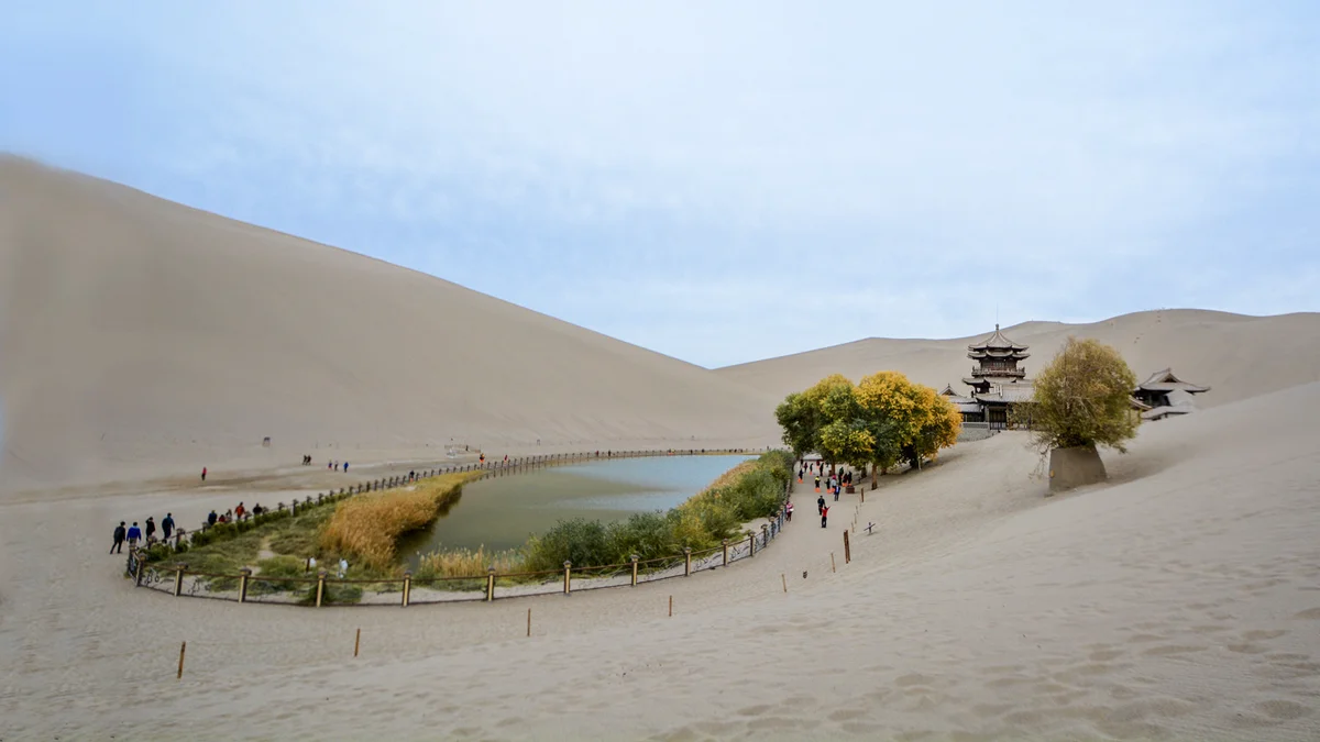 The legendary Crescent Lake shimmering blue against golden dunes