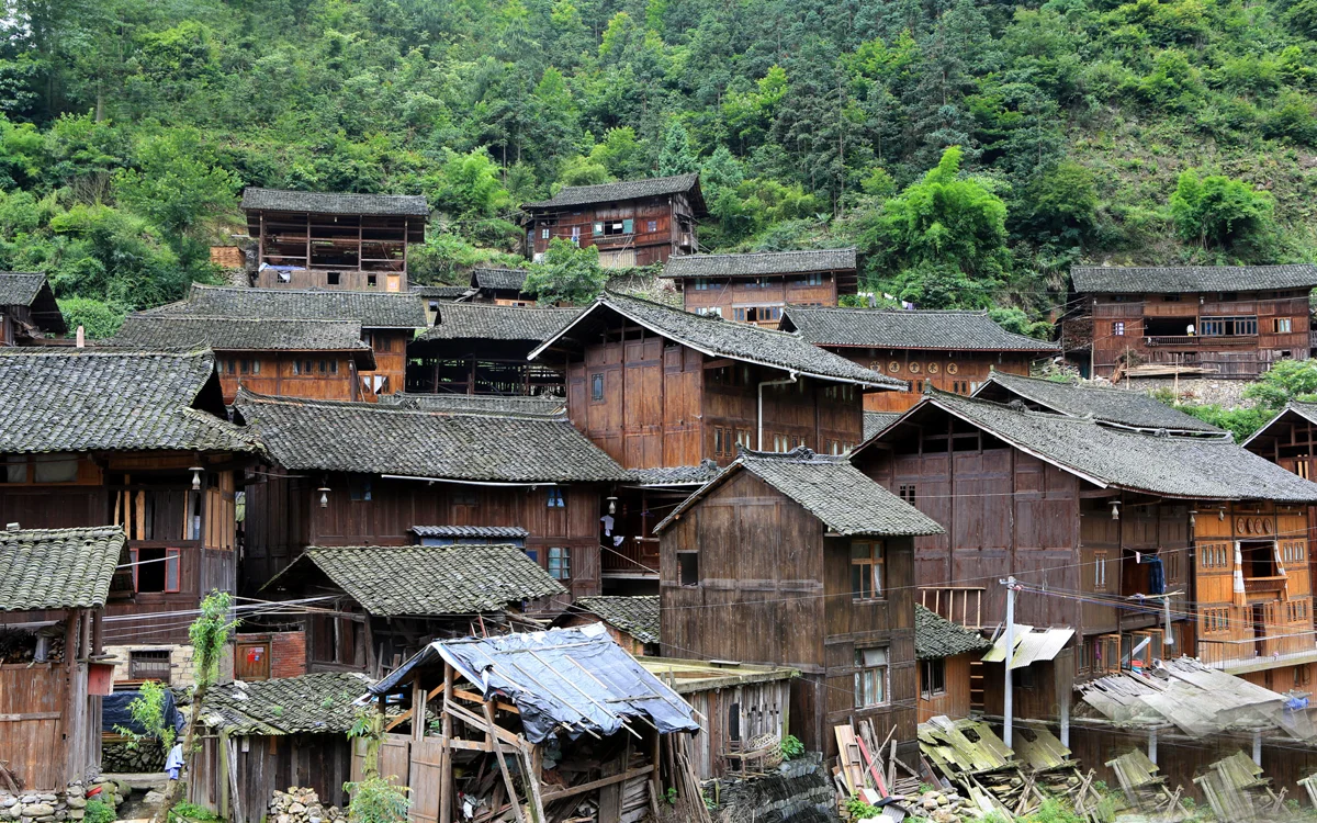 Xijiang Miao Village at night with lights and mountains