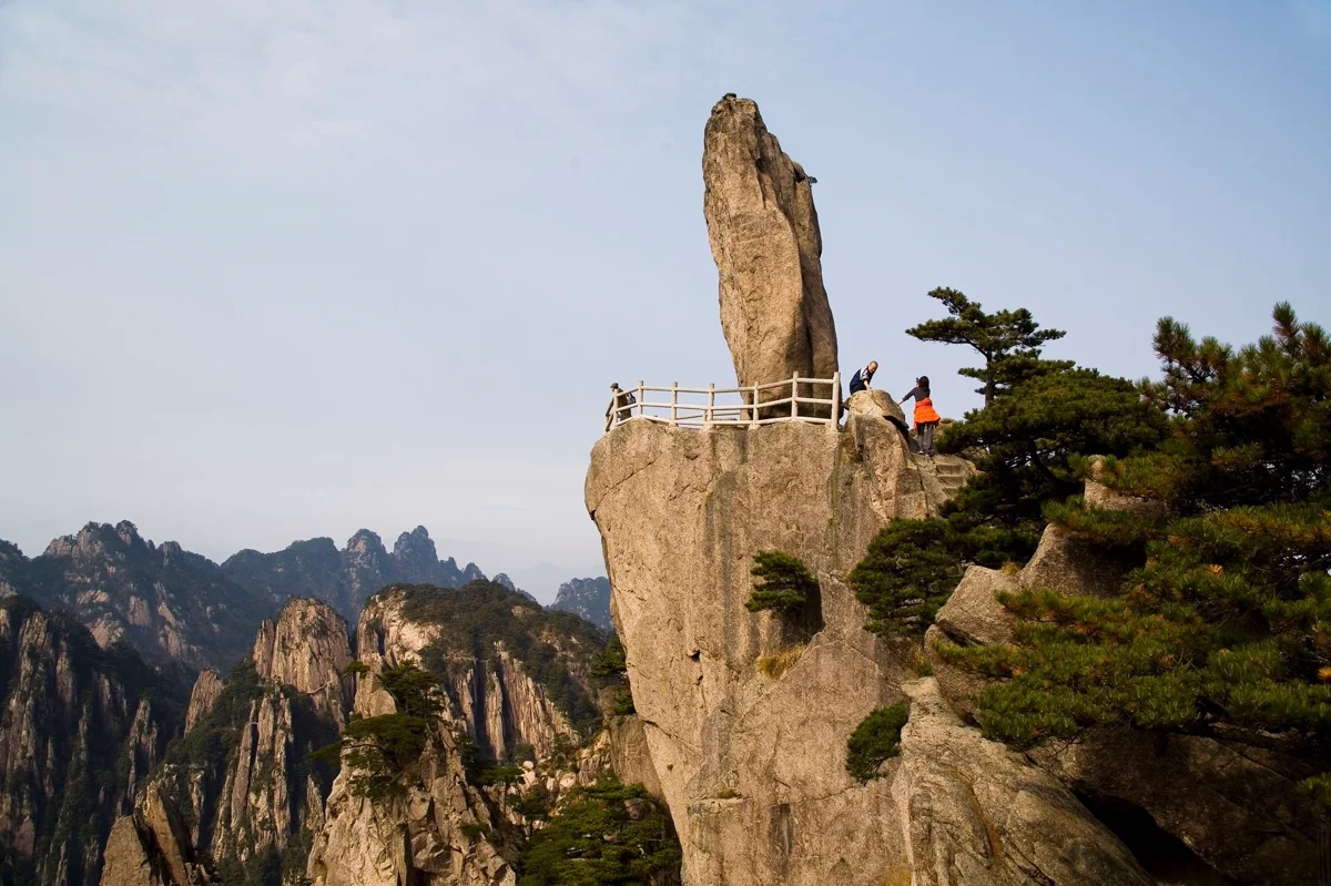 Granite peaks covered in ancient pine trees with dramatic mountain scenery
