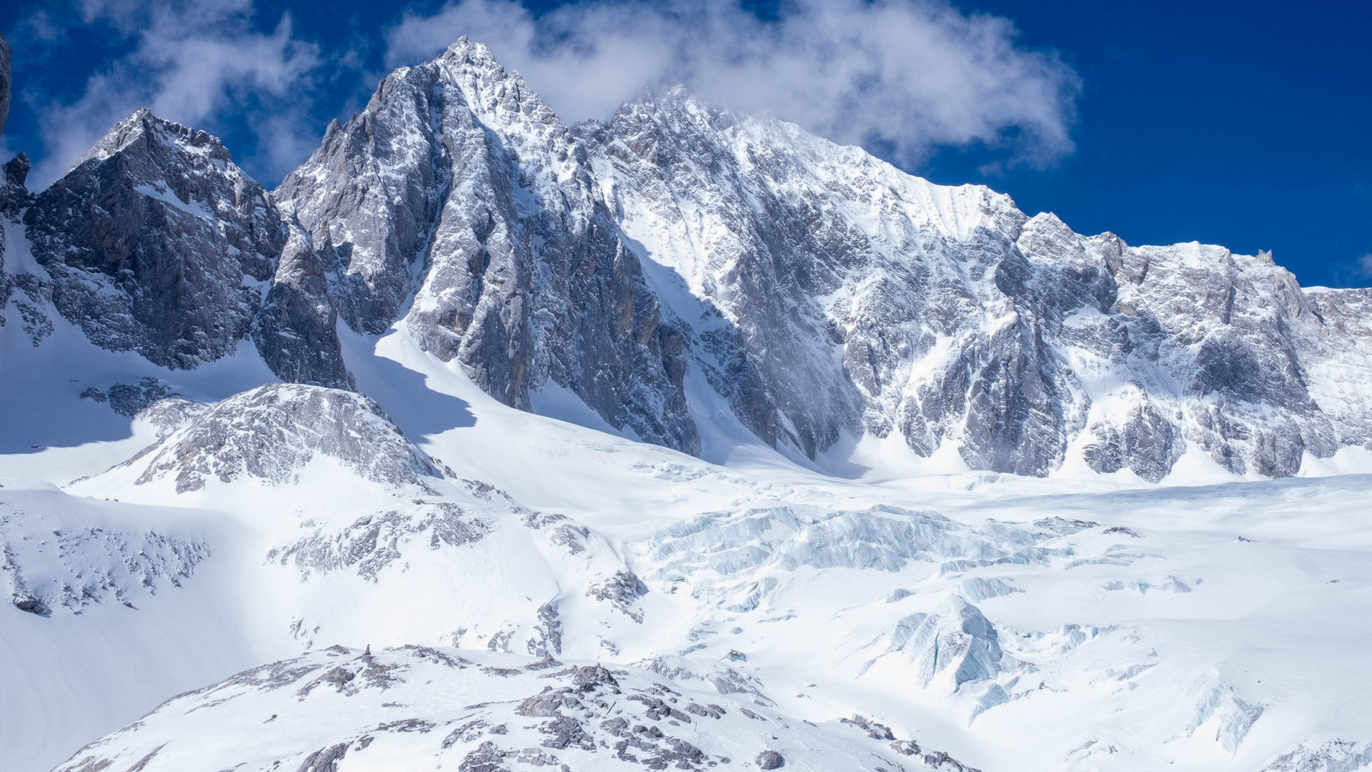 Jade Dragon Snow Mountain towering peak with clouds
