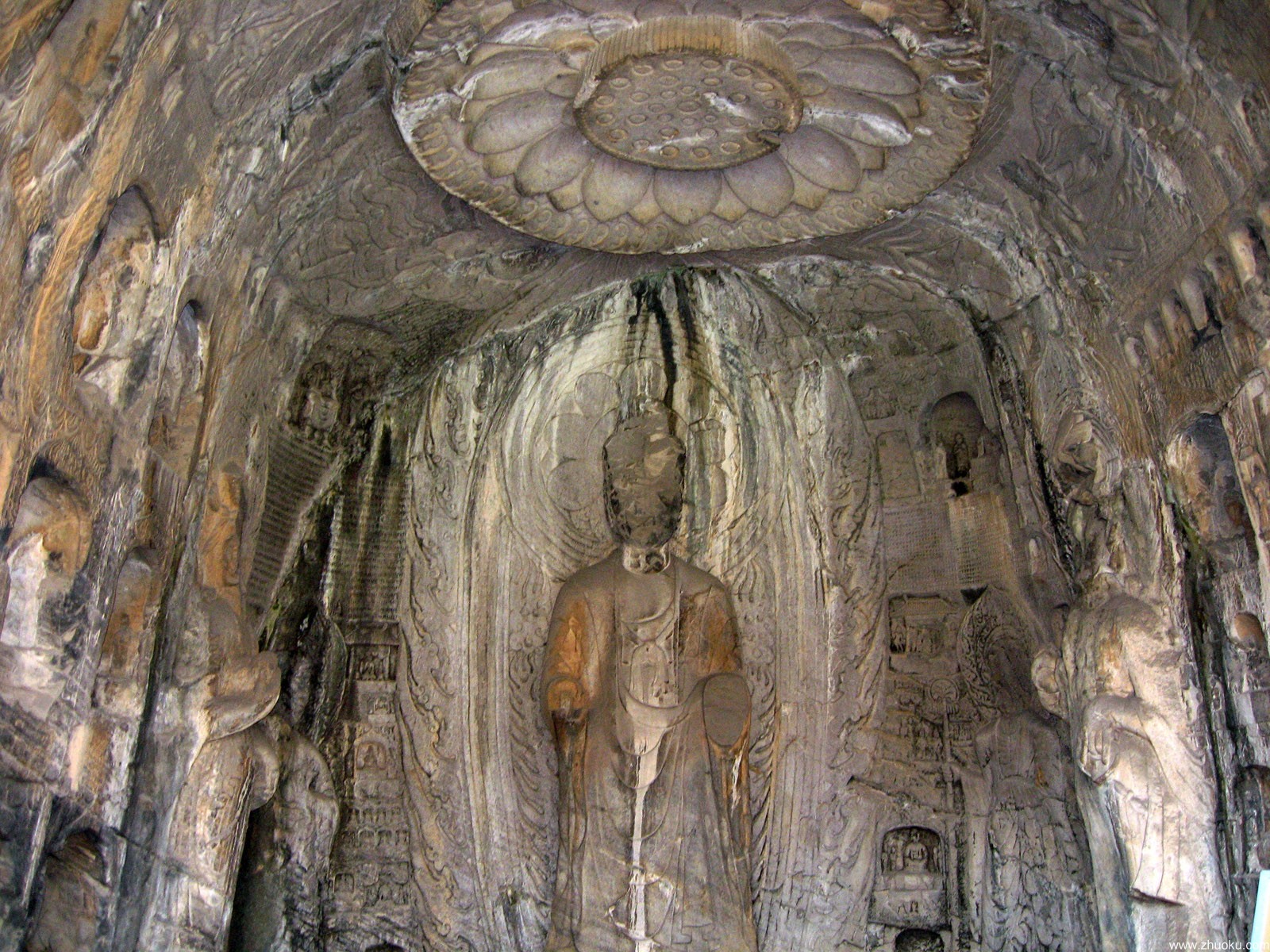 Mountain path with Buddhist statues carved into cliff