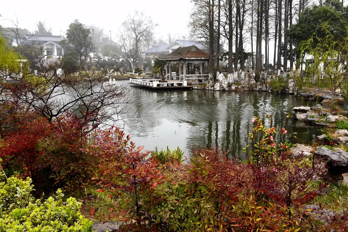 Xuanwu Lake with its elegant bridge, pagoda, and lush green surroundings
