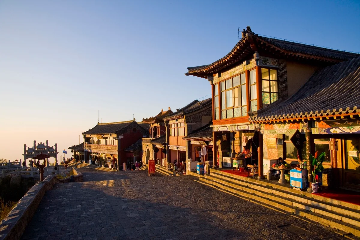 Golden sunrise breaking over the horizon from Mount Tai summit