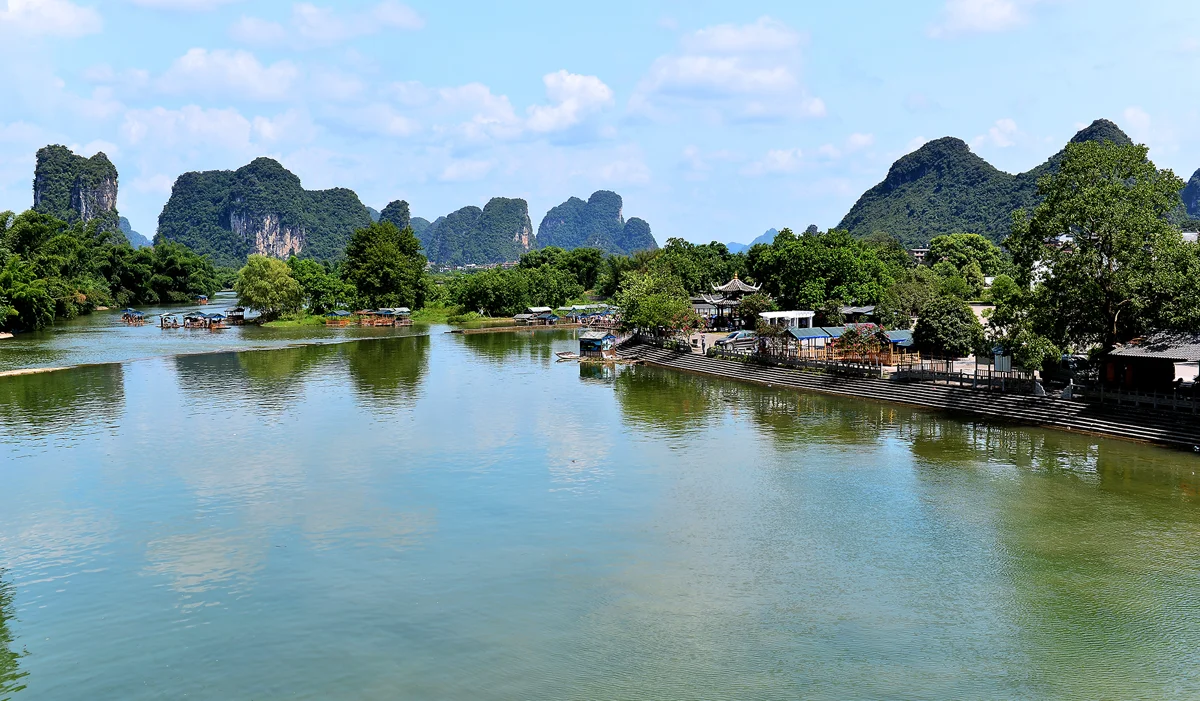 Bamboo raft drifting down the crystal-clear Yulong River