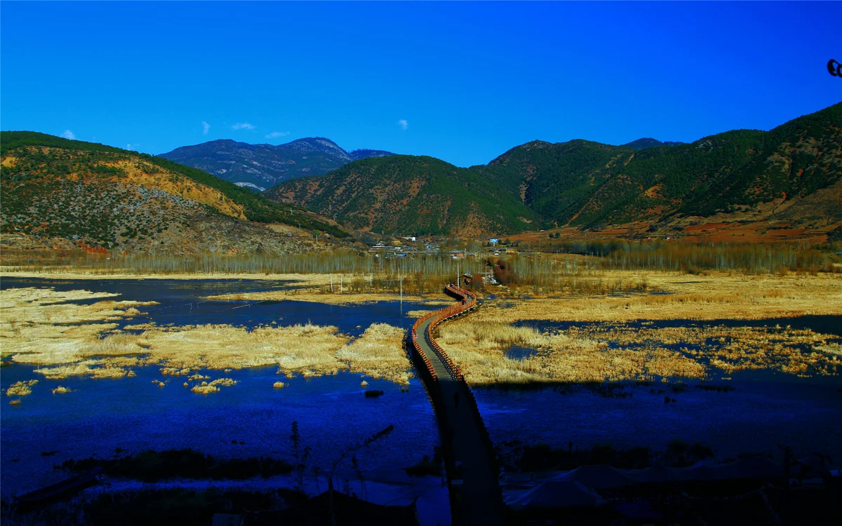 Lugu Lake with boardwalk and mountain reflection